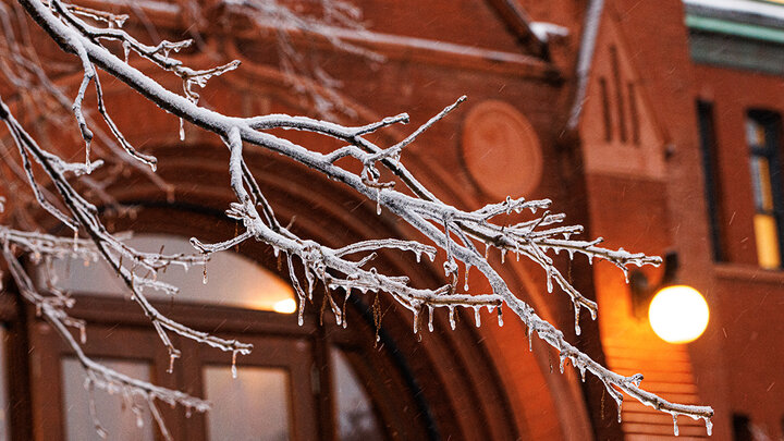 Ice and snow cover campus and are back lighted by the lights on Architecture Hall.